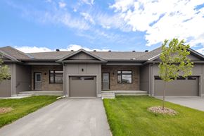 Arnprior apartment for rent - the front of a house with a driveway and a tree