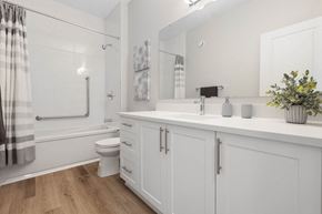 Arnprior apartment for rent - a white bathroom with a large mirror and a toilet