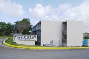 Tamuning apartment for rent - a white building with a sign in front of it