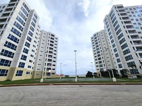 Tamuning apartment for rent - A parking lot in front of a large building.
