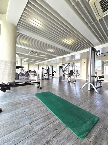 Tamuning apartment for rent - A gym with a green mat in the foreground.