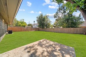 Houston house for rent - a backyard with a grass lawn and a fence