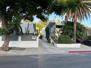 Los Angeles apartment for rent - A tree is in front of a house with a sign that says "Earth Right".