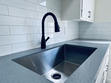 Los Angeles apartment for rent - A modern kitchen with a stainless steel sink and a black faucet.