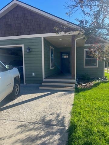 Whitefish apartment for rent - A white truck is parked in front of a green house.