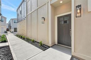 Houston house for rent - the front door of an apartment building with a sidewalk