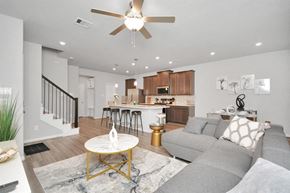 Houston house for rent - a living room and kitchen with a couch and a ceiling fan