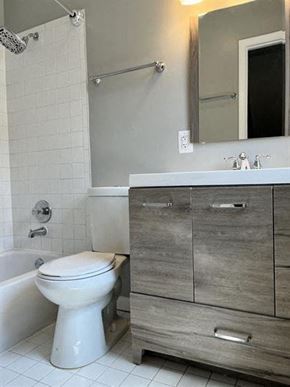Washington apartment for rent - a bathroom with a toilet and a sink and a mirror