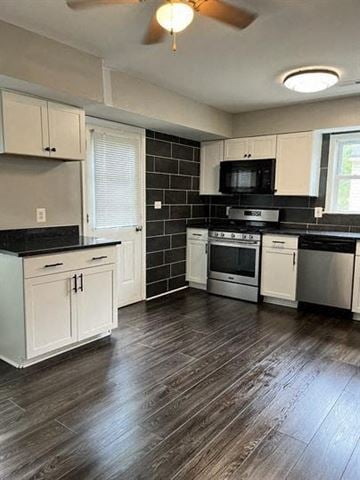 Washington apartment for rent - a kitchen with white cabinets and a stove and a microwave
