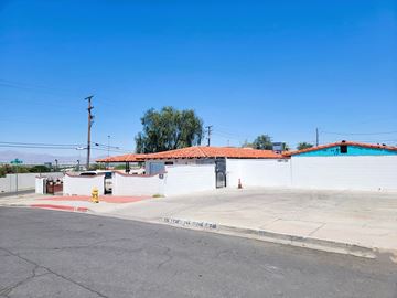 Las Vegas apartment for rent - a white building with a red roof and a yellow fire hydrant