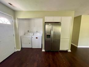 New Albany apartment for rent - A kitchen with a white door, a white dishwasher, and a silver refrigerator.