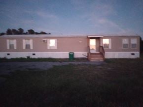 Beech Island house for rent - A building with a green trash can in front of it.