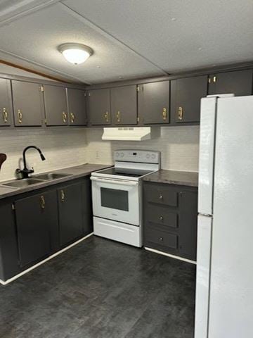 Beech Island house for rent - A kitchen with a white refrigerator, black cabinets, and a white stove top oven.