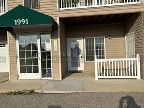 Rochester apartment for rent - the front entrance of a house with a porch and a green roof