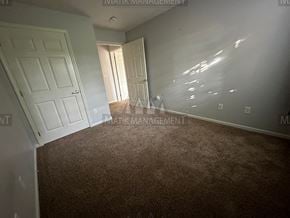 Rochester apartment for rent - a bedroom with a carpeted floor and a door