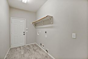 Pearland house for rent - A white door is in a room with a shelf above it.