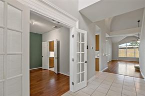 Pearland house for rent - A room with white doors and a green wall.