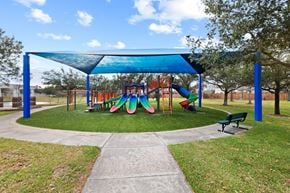 Rosharon house for rent - A playground with a blue canopy and a slide.