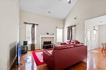 Rosharon house for rent - A living room with a red couch and a fireplace.