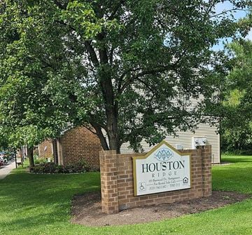 Montgomery apartment for rent - a sign in front of a tree and a building