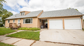 Moorhead apartment for rent - A two-car garage is attached to a house.
