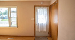Moorhead apartment for rent - A room with a door, window, and a mat on the floor.