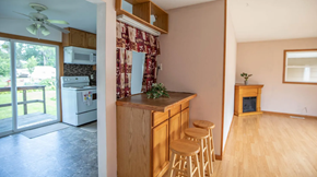 Moorhead apartment for rent - A kitchen with wooden cabinets and a countertop with a plant on it.