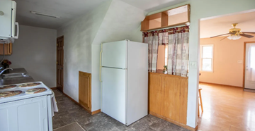 Moorhead apartment for rent - A kitchen with a white refrigerator and a wooden counter.