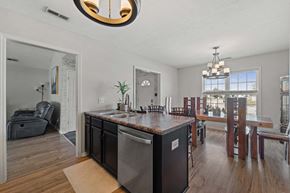 Jacksonville house for rent - a kitchen and dining room with a large island and a dining room table