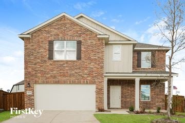 Forney house for rent - a brick house with a white garage door