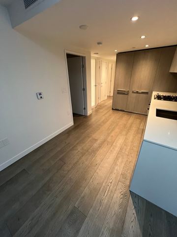 Vancouver apartment for rent - A kitchen with a white counter top and wooden floors.