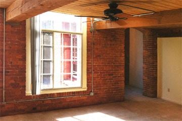Vernon apartment for rent - an empty living room with a window and a ceiling fan