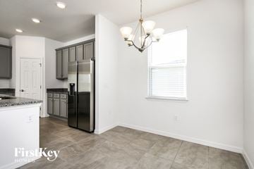 Bartow house for rent - a kitchen with a refrigerator and a window