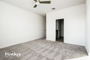 Bartow house for rent - an empty living room with white walls and a ceiling fan