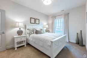 Aiken apartment for rent - A white bedroom with a large bed and two lamps.