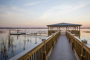 Orlando apartment for rent - a dock with a gazebo on the water at sunset