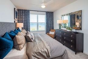 Orlando apartment for rent - a bedroom with a large bed and a dresser