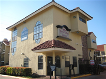 Dallas apartment for rent - A small yellow building with a red tile roof.