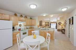 Cuyahoga Falls apartment for rent - a kitchen and dining room with a white table and chairs