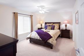 Cuyahoga Falls apartment for rent - a bedroom with a bed and a ceiling fan