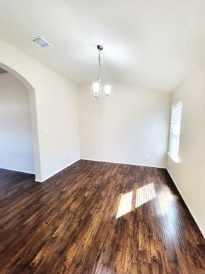 Killeen house for rent - an empty living room with wood flooring and white walls