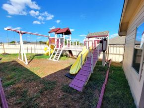 Killeen house for rent - a playground with a playset and slides in a backyard