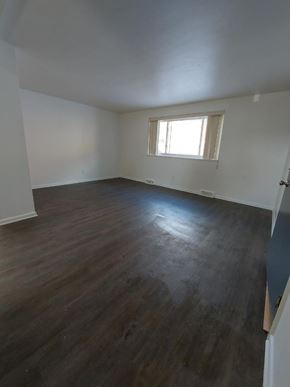 Bedford apartment for rent - A room with wooden floors and a window.