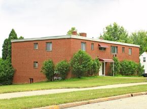 Bedford apartment for rent - A red brick building with a white door and windows.