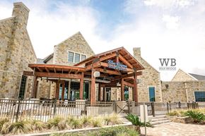 La Marque townhouse for rent - A building with a wooden entrance and a sign that says "Wain Bridge".