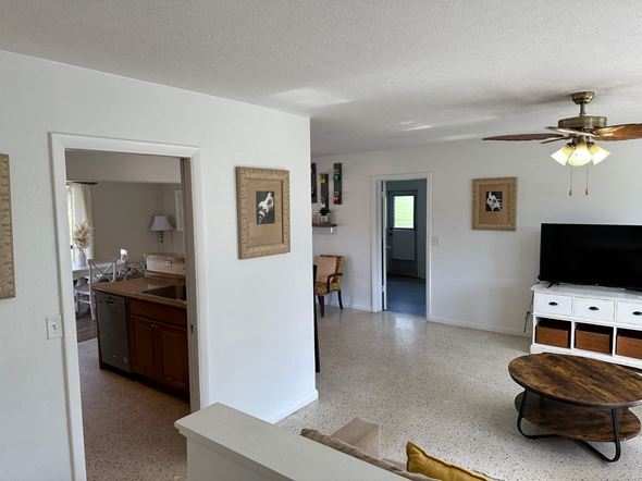 Bradenton house for rent - a view of a living room and a kitchen with a tv