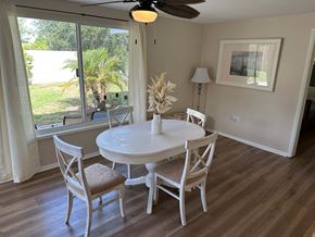 Bradenton house for rent - a dining room with a table and chairs and a large window