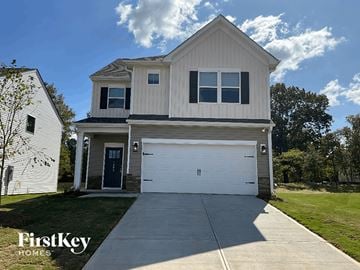 Greenville house for rent - a white house with a white garage door