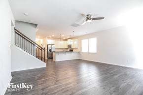 Greenville house for rent - A spacious room with wooden floors and a staircase on the left side.