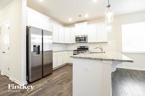 Greenville house for rent - A kitchen with a refrigerator, microwave, and sink.